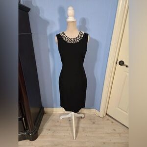 Elegant Black Sleeveless Dress with Embellished Neckline